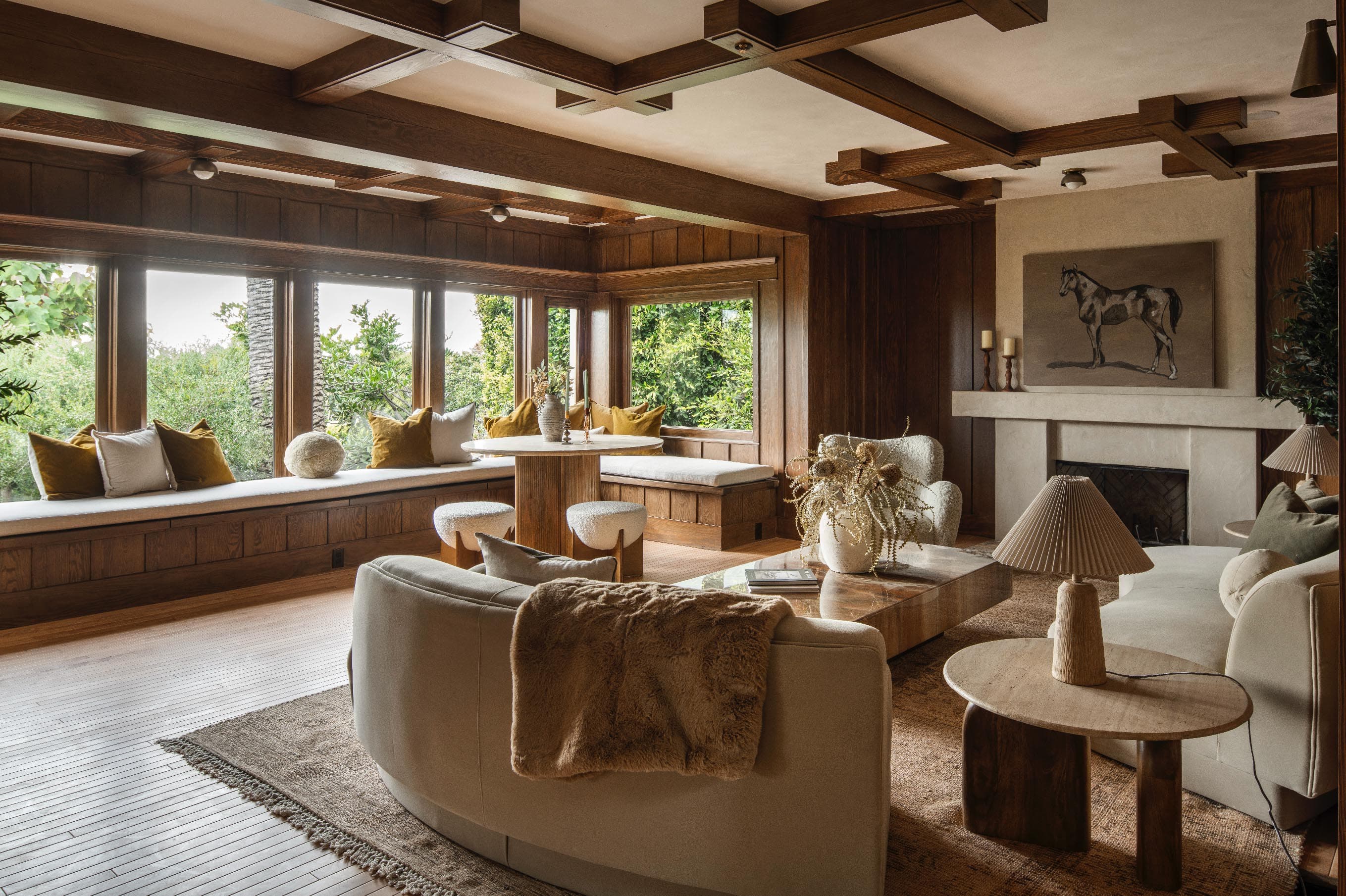 Warm craftsman living room with coffered ceiling, fireplace, and window seat