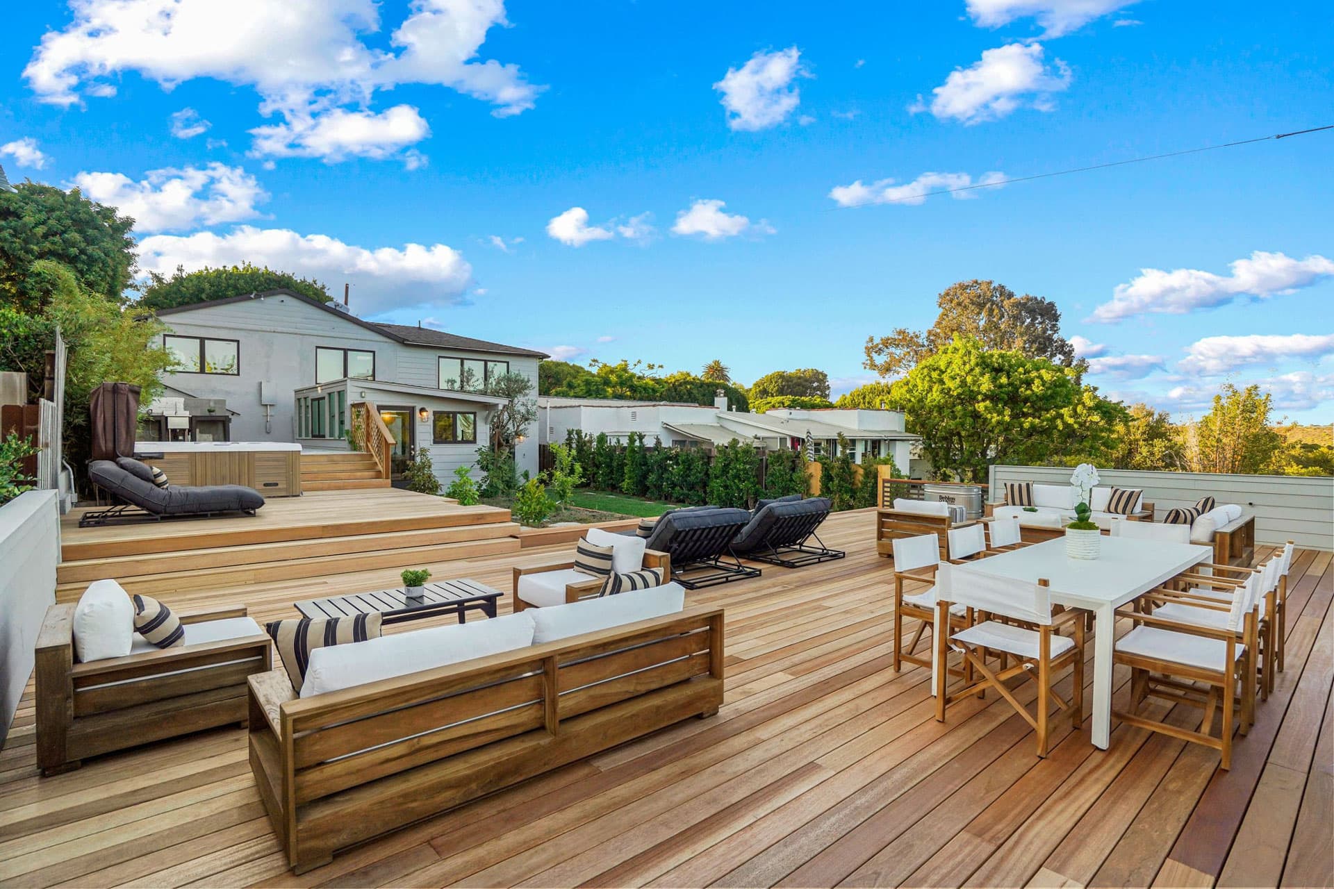 Modern outdoor deck with dining and lounge areas